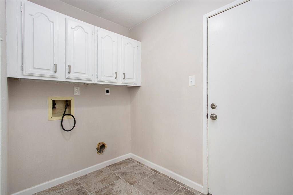 Laundry Room Between the Garage and Kitchen - Recently Painted Cabinets with added Hardware