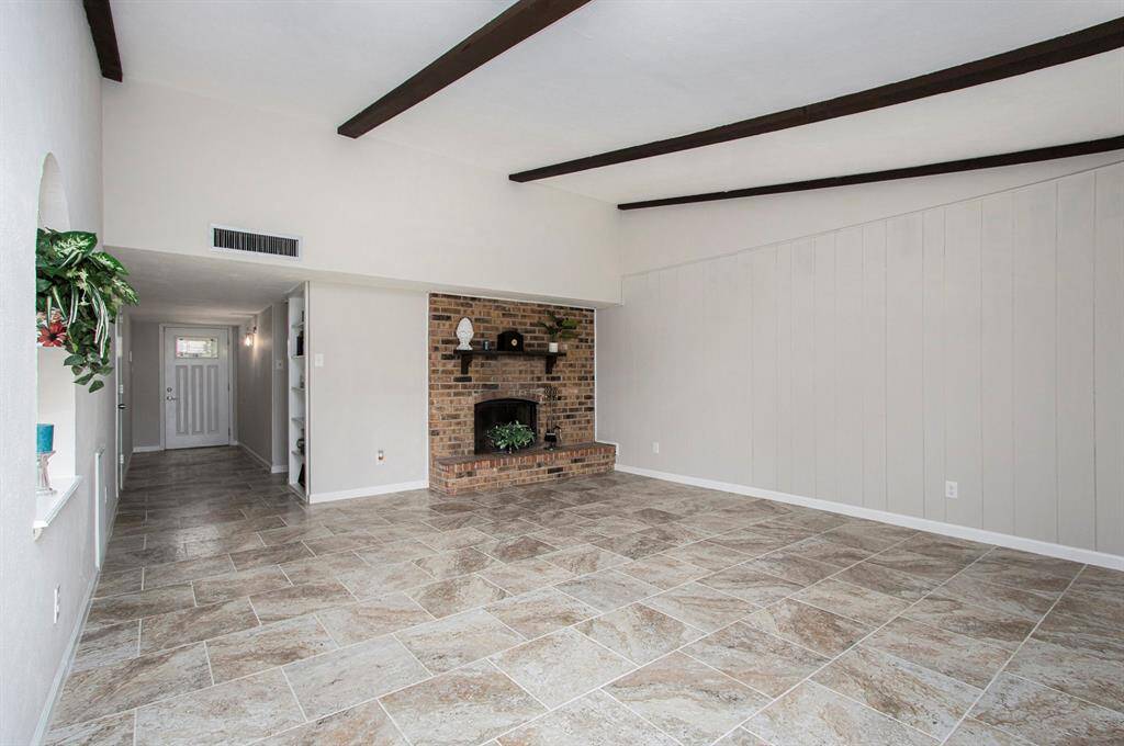 Family Room - 16'5"x19'5" Features a Woodburning Fireplace and Vaulted Beamed Ceiling