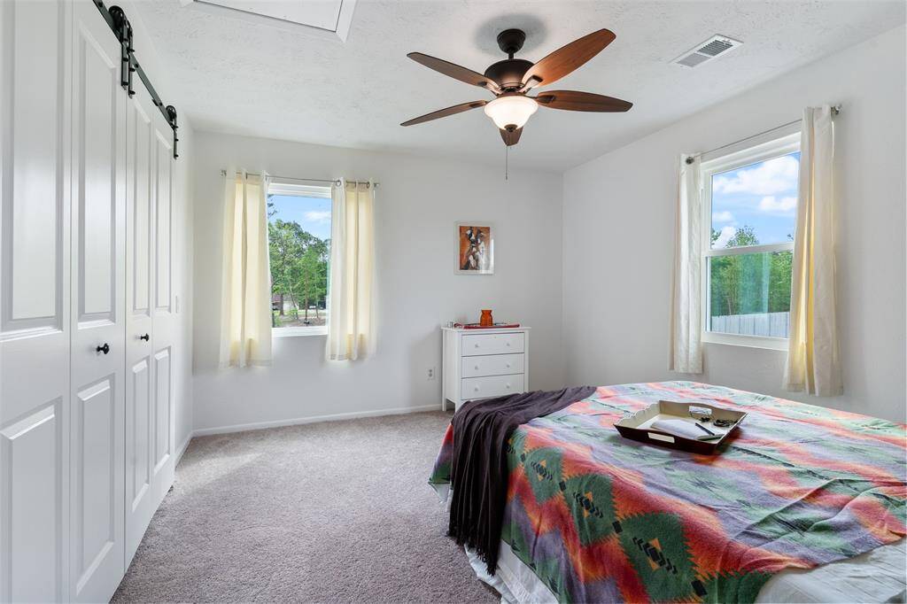Bedroom 2 with barn door style closet doors