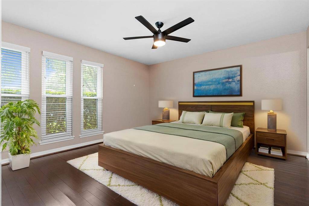 Down the hallway tucked away is the beautiful Owners suite!  Gorgeous wood floors, sleek chic ceiling fan and more!  Virtual staging