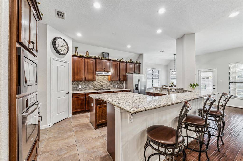 Additional view of the kitchen and ample seating at the island