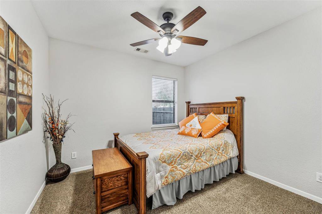 Bedroom with ceiling fan and closet