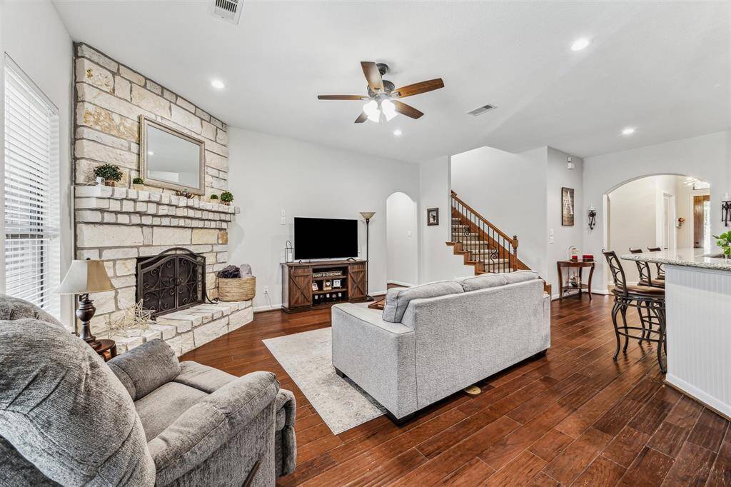 Additional view of the living room, stairwell pictured center leads to the game room