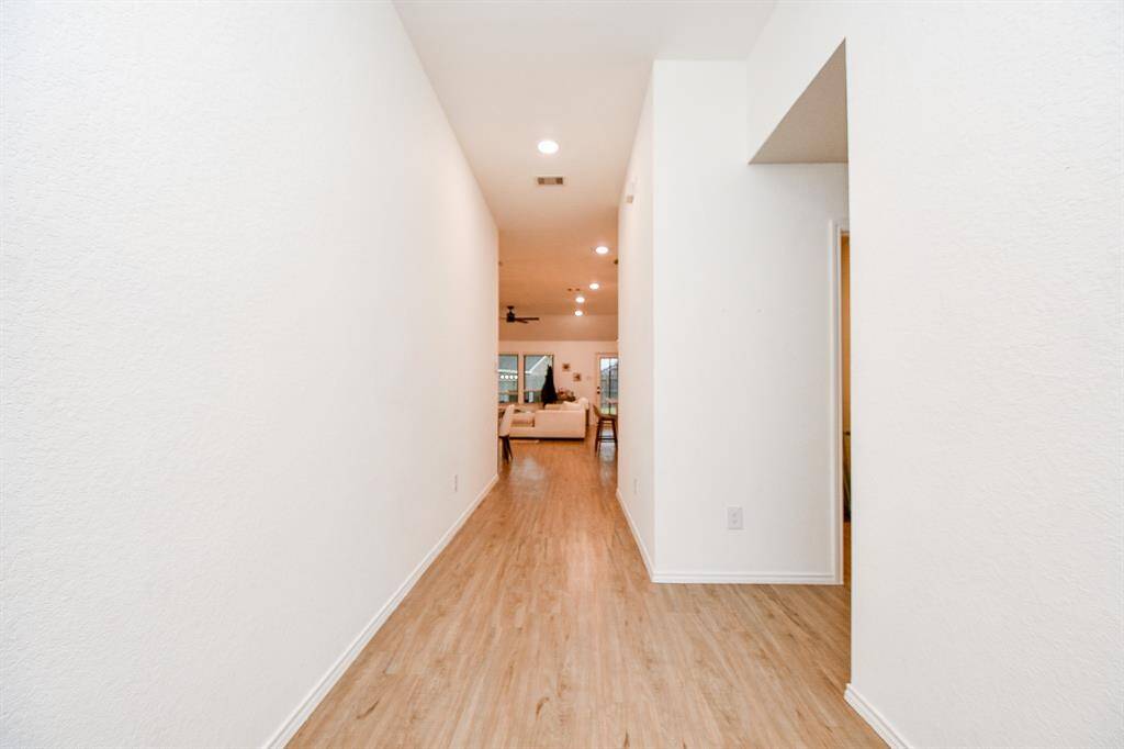 The entryway exudes warmth and sophistication, inviting you into the home with a sense of charm and elegance. This thoughtfully designed front door perfectly sets the tone for the beauty and style found within.