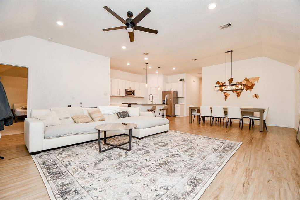 The neutral color palette and high ceilings create an elegant yet relaxed setting, perfect for both family gatherings and quiet moments.