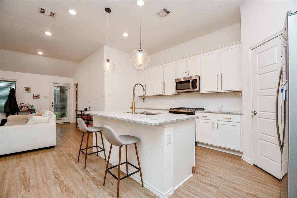 With an open layout that flows seamlessly into the living and dining areas, the kitchen is both stylish and practical, making it the perfect spot for culinary creativity and everyday convenience.