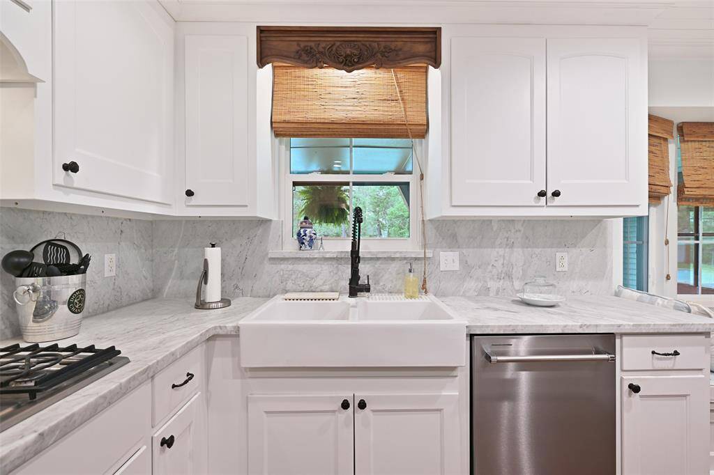 The kitchen is open to the living room, and exudes timeless elegance.