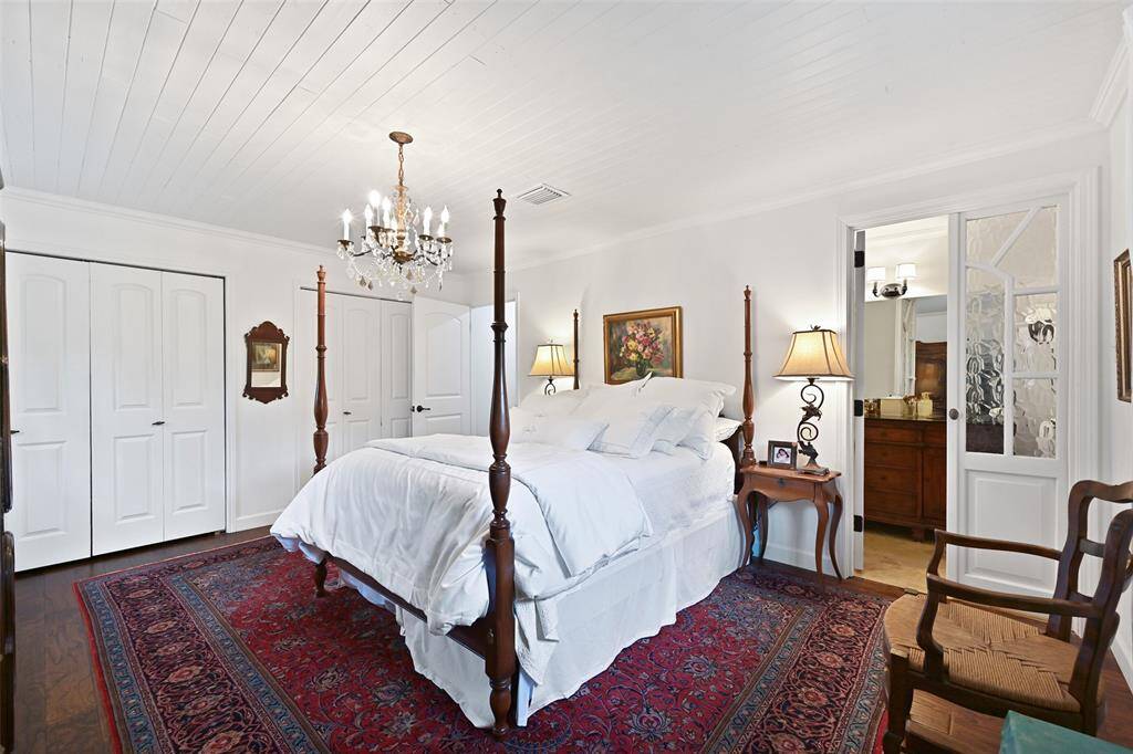 Antique French chateau doors conceal the stainless steel KitchenAid fridge and add character and charm to the space.