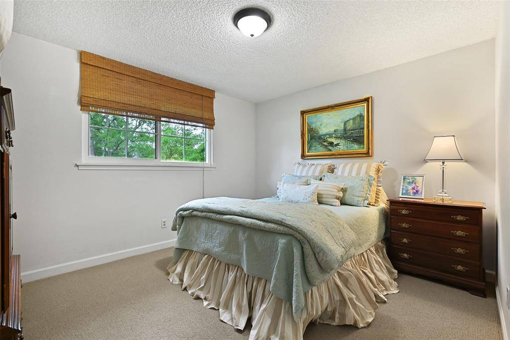 The first of the secondary bedrooms is spacious and features new carpet and a walk-in closet.