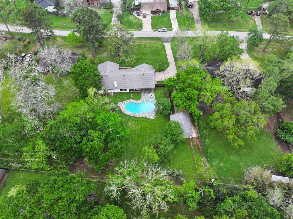 The yard's green space is immense, providing TONS of space to play, entertain, garden, or relax. Notice the barn to the right. It has been fully re-sided, and has full electricity.