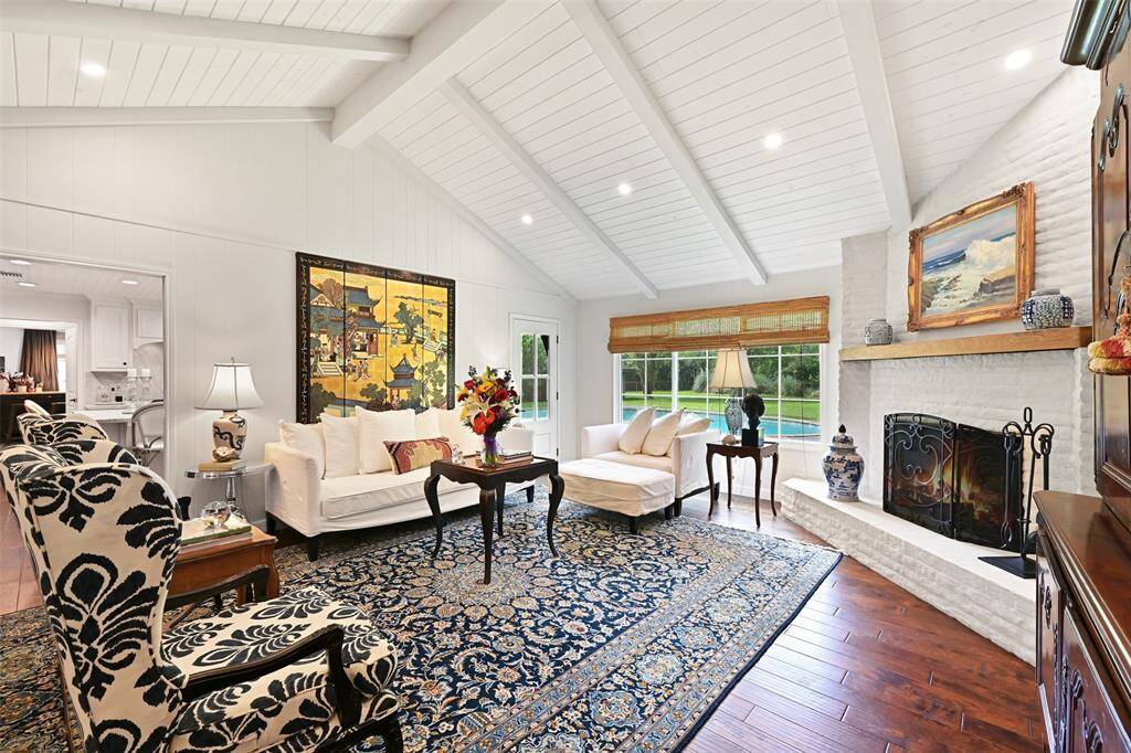 This house has been completely remodeled by its professional artist owner. A wall was torn down between the dining room and living room, connecting the two spaces with eyebrow arched casings.