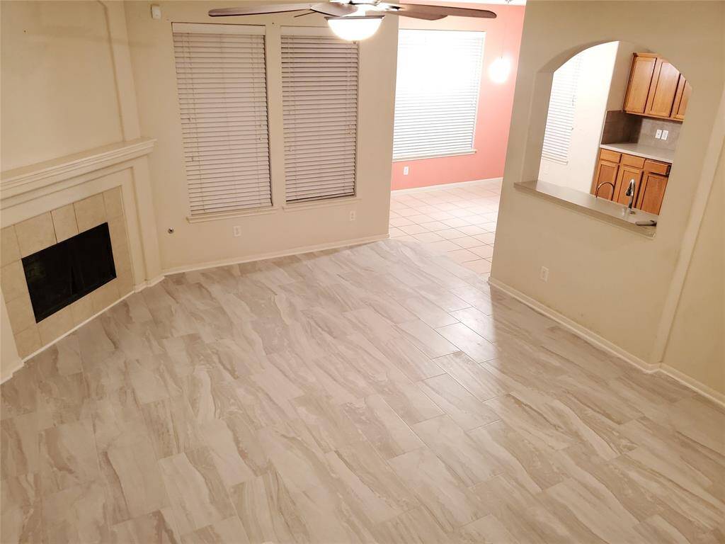 View of the living room to kitchen. Look at the beautiful new tile running throughout the house...
