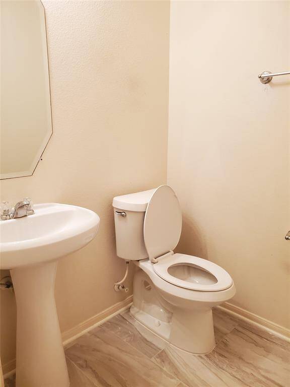 half bath in the hallway with new toilet bowl