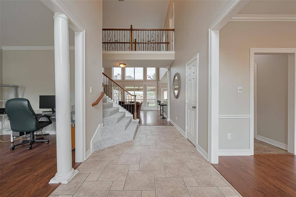 Foyer opens to the back of the home and featured staircase with new carpeting!