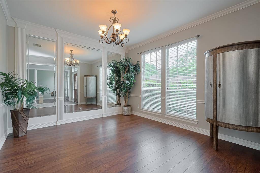 Formal dining with crown molding, chair rail and feature mirror wall