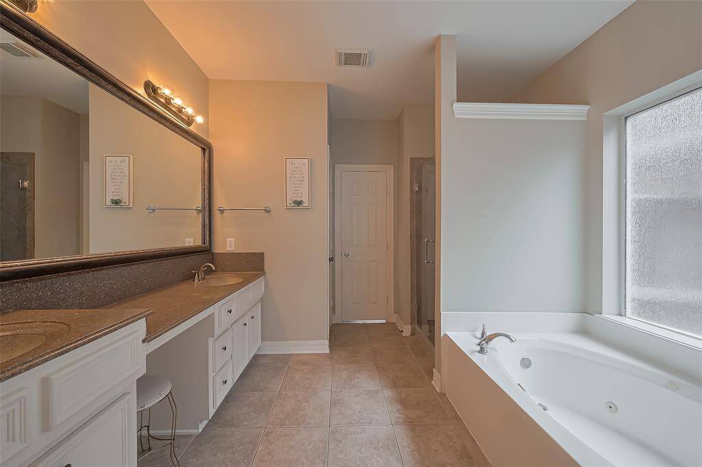 Ensuite features jacuzzi tub and separate shower