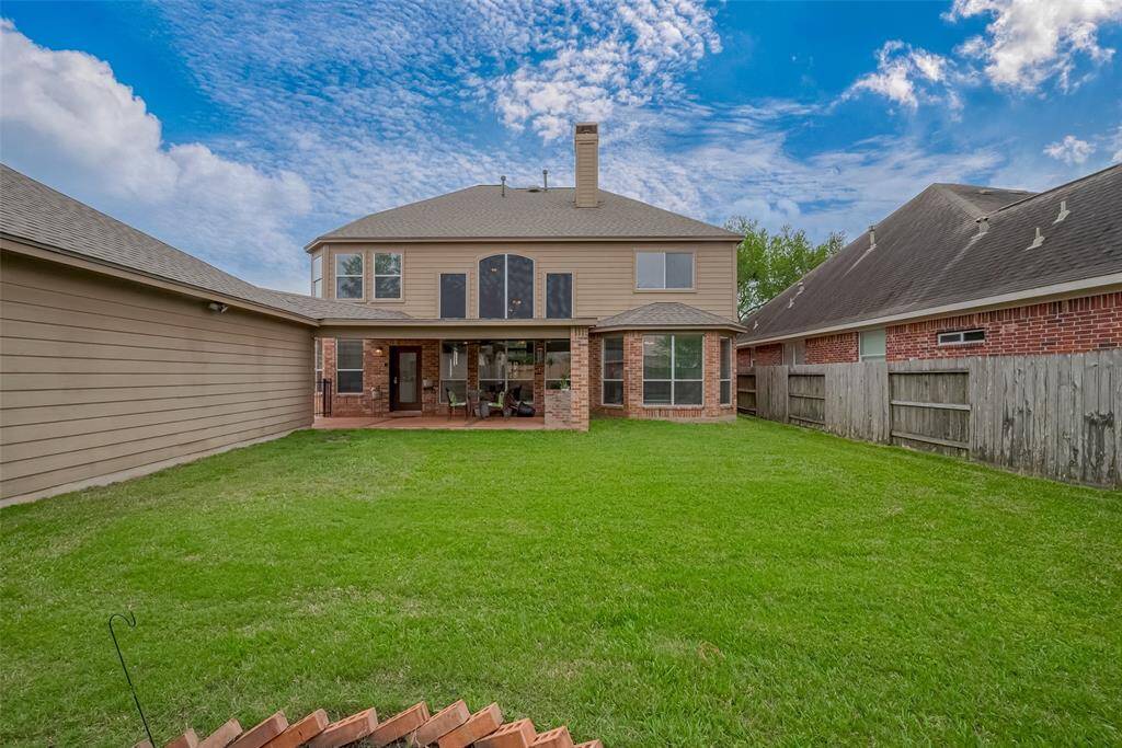 The back of the home is loaded with large windows for more natural light. Exterior is cement board and brick