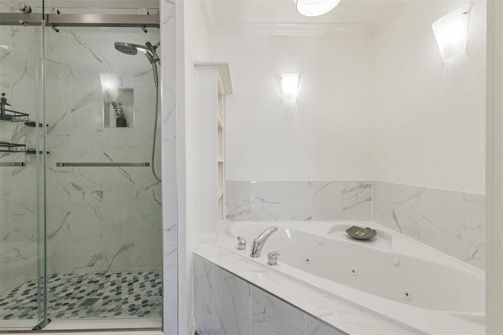 To the left of the tub is the separate standing shower.