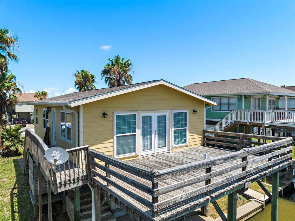 Spacious upper deck overlooking the canal, perfect for soaking up the sun or dining al fresco. French doors lead directly into the living room for seamless indoor-outdoor living.