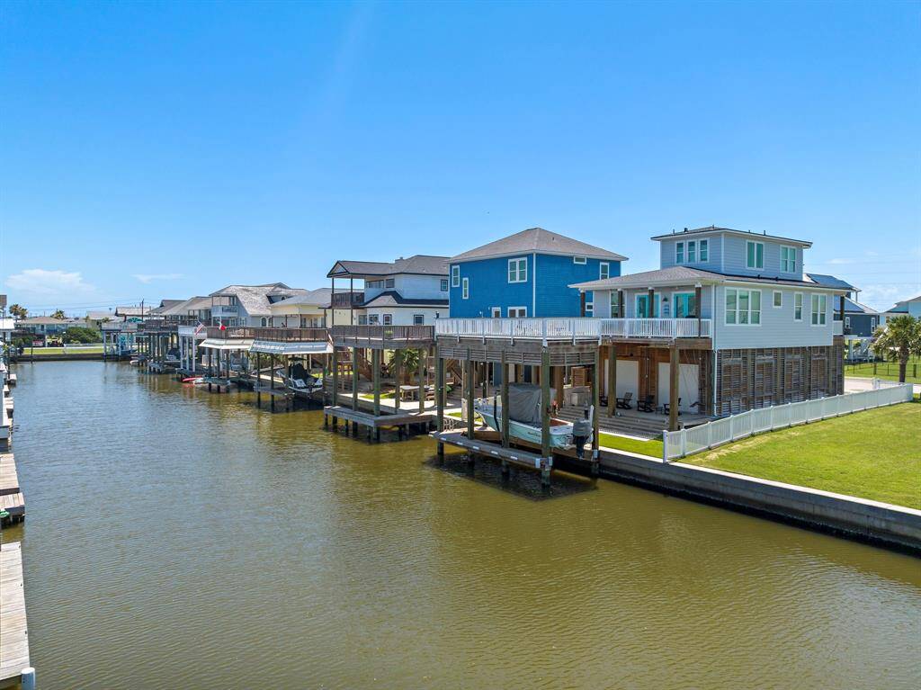 Calm waters and coastal homes line the canal, offering covered decks and boat lifts—an ideal setting for water-loving homeowners.