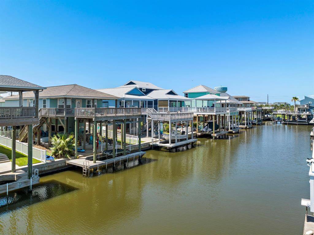 A tranquil canal lined with charming coastal homes—perfect for paddleboarding, kayaking, or boating for quick bay adventures.