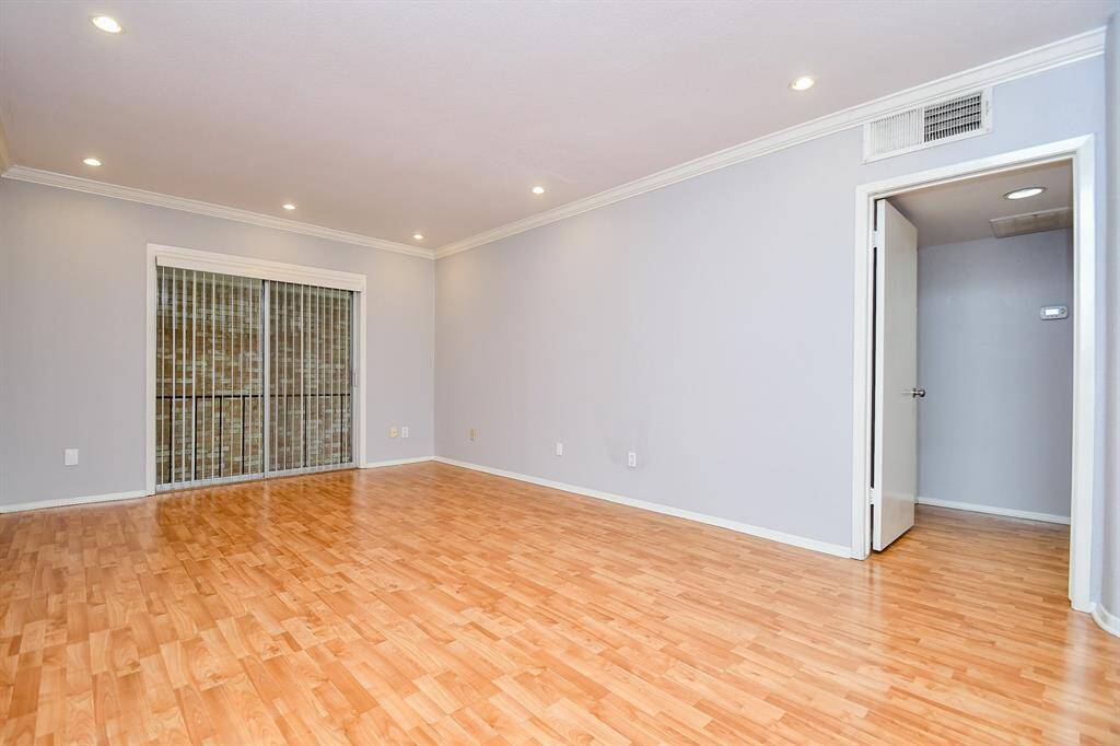 The open door leads to the hallway opening to the bedroom and bath suite.