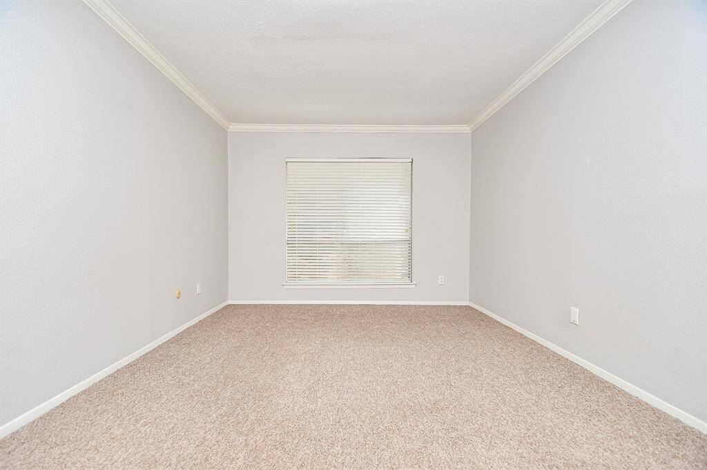 The neutral color scheme continues into the roomy bedroom.