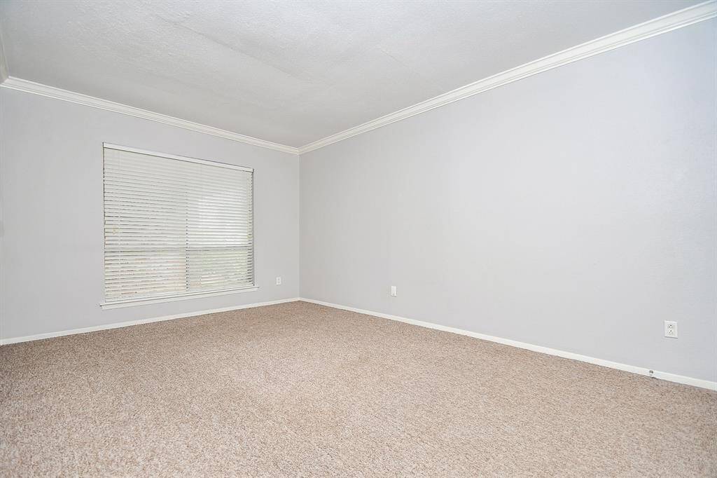 The large window lets in lots of natural light while the blinds provide privacy.  The neutral toned carpet and paint make this a room perfect for your personal design touches.