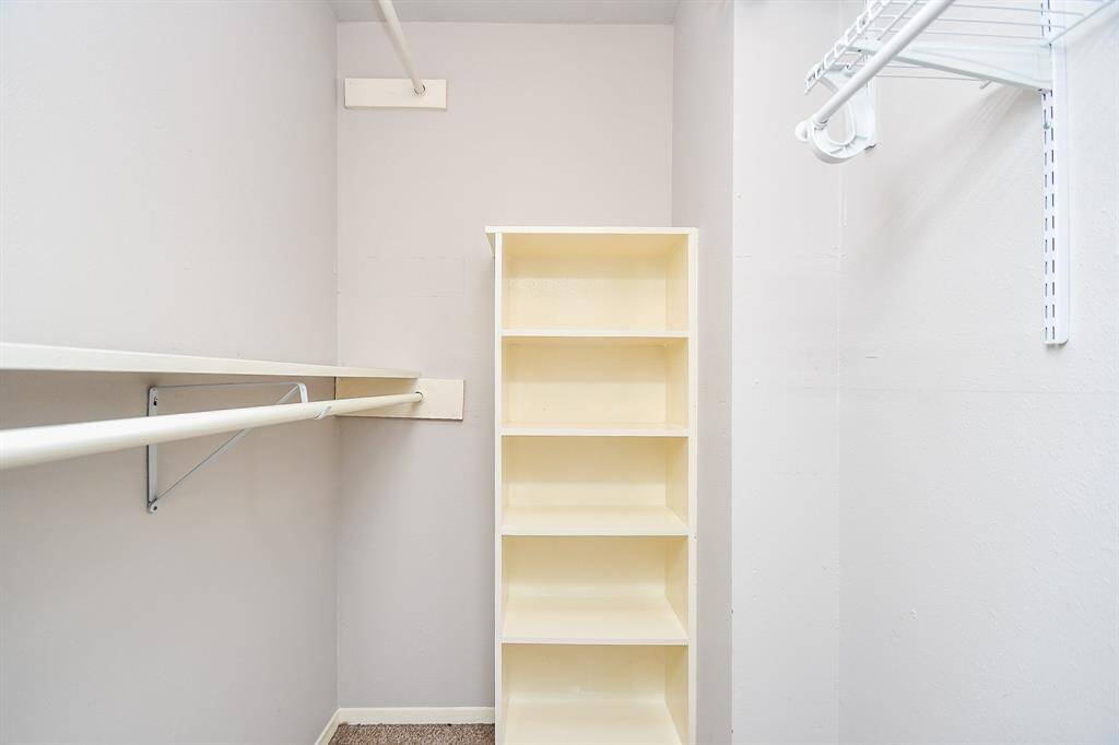 The spacious walk in closet has an abundance to storage space.