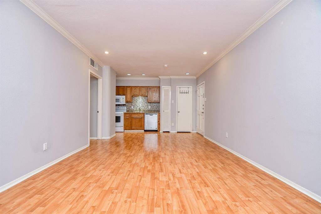 The spacious living area is large enough for den furniture and a dining table.