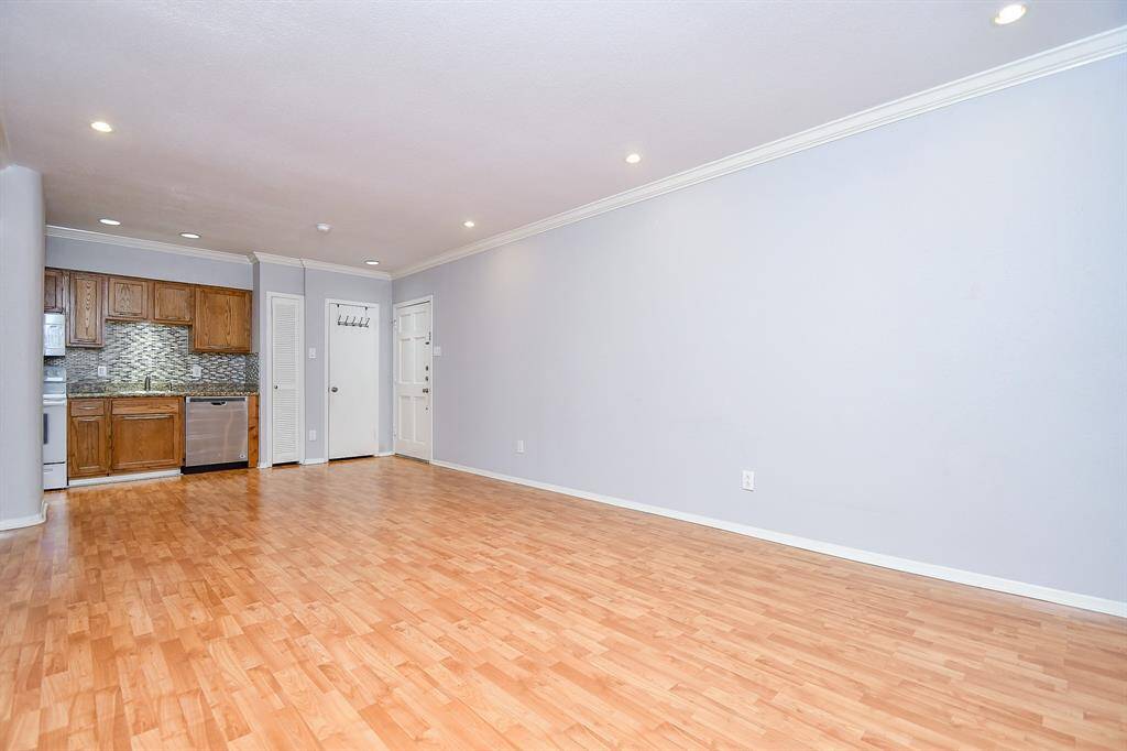 The updated kitchen is compact, but has an abundance of storage space! A stackable washer & dryer fits and can be easily installed in the spacious storage area behind the far right door.