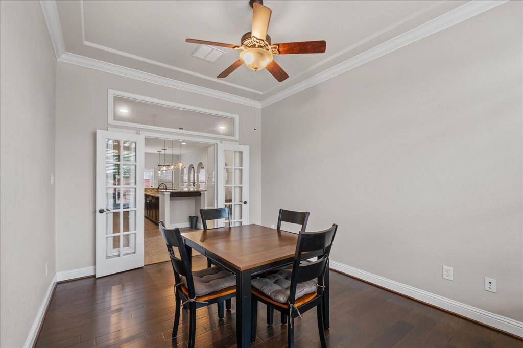 The Office/study opens into a kitchen through elegant French doors, providing an inviting and open layout perfect for gatherings.