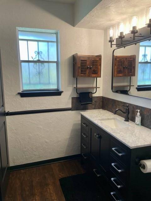 Primary bathroom pic with natural lighting, overhead heater, and dimmer for vanity lights