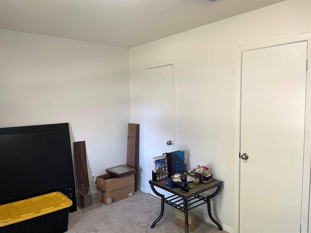 Nice size secondary bedroom features a charming arched window overlooking the front yard, filling the space with natural light and two closets