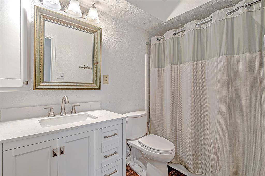 Bright and clean secondary bathroom with an updated new vanity, sleek fixtures, and a shower/tub combination, perfect for guests or family use.