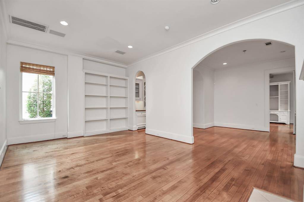 Step inside to the foyer to be greeted by gleaming hardwood floors & arched entryways. Formal living room with gas fireplace, providing access to the formal dining room.
