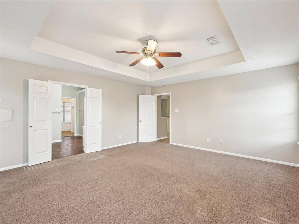 The Primary Bedroom is generous and features a tray ceiling;.