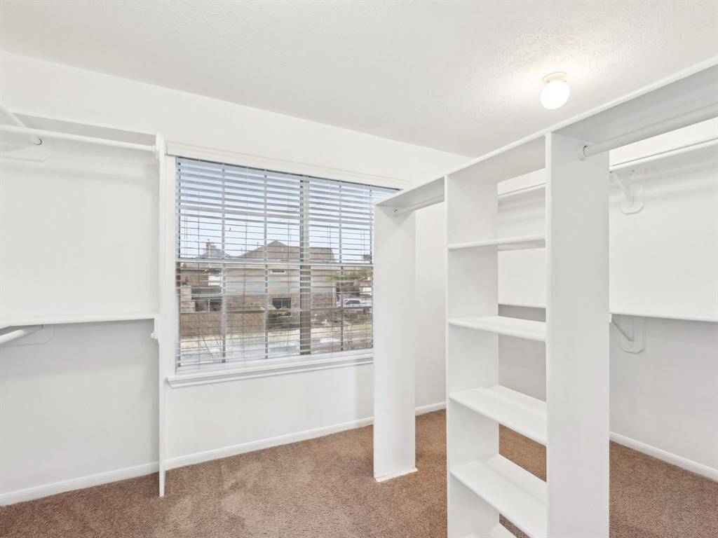 The Primary closet is huge and features shelving for shoes, handbags and hats.