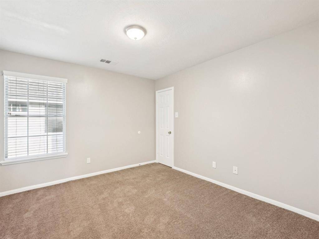 Bedroom 2 is roomy and overlooks the backyard. It has a walk-in closet.