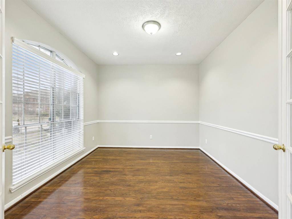 The Study also has chair rail molding and wood flooring.
