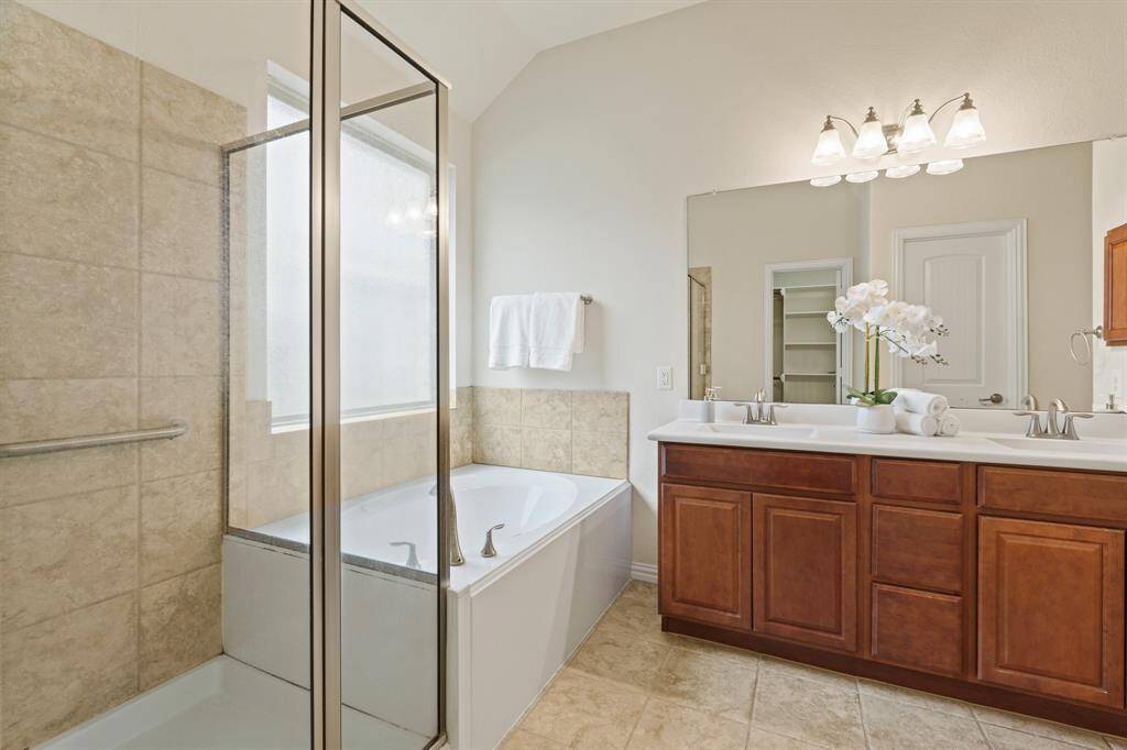 Take one more peek at your new luxurious ensuite bathroom with a dual sink vanity, lining closet, relaxing jetted tub, and oversized walk-in shower.