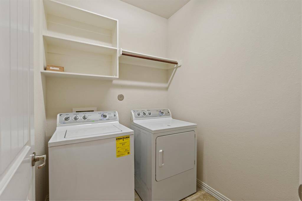 The utility area is conveniently located near the guest bathroom and kitchen. It offers built-in shelving for household storage and a convenient hanging bar for clothes. As an added bonus, the washer and dryer are included!