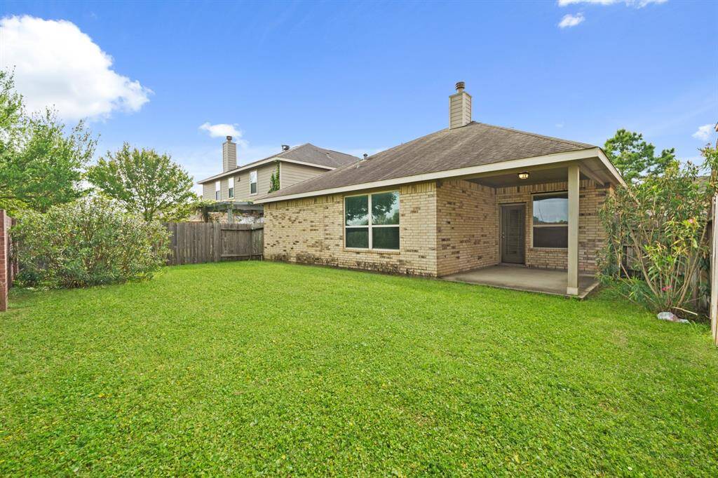 You’re going to love the sprawling fenced yard, offering plenty of room for barefoot fun, a sprinkler system for easy care, and a large covered patio perfect for year-round enjoyment.