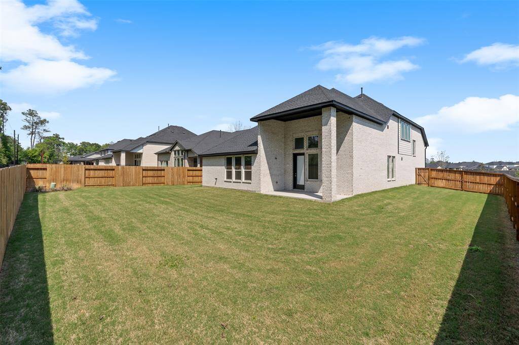 The home has a spacious backyard and covered patio