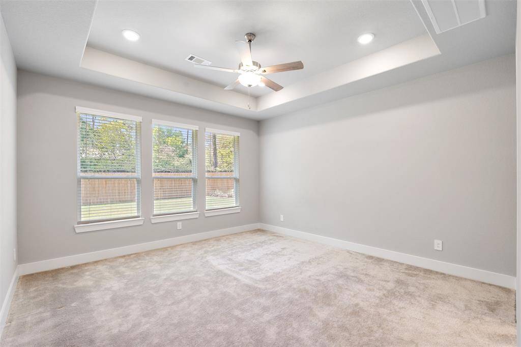 Large primary bedroom with views of the backyard, no back neighbors