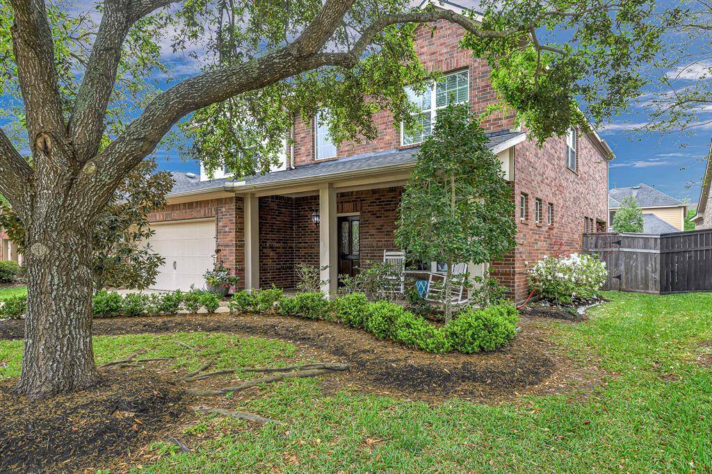 Spacious all brick front porch with room for rocking chairs make this space nice for relaxing with morning coffee or evening chats.