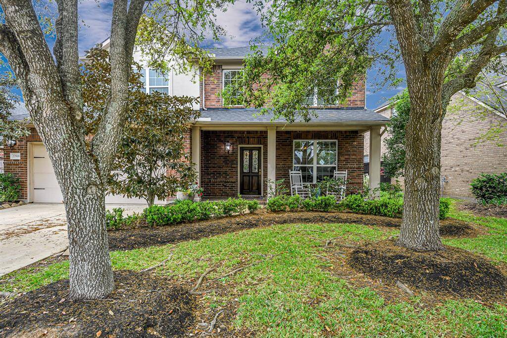 Spacious double-wide driveway offers plenty of room for multiple vehicles, making daily parking and guest visits a breeze. Beautifully framed by mature trees and lush landscaping, it adds both convenience and curb appeal to the front of the home.