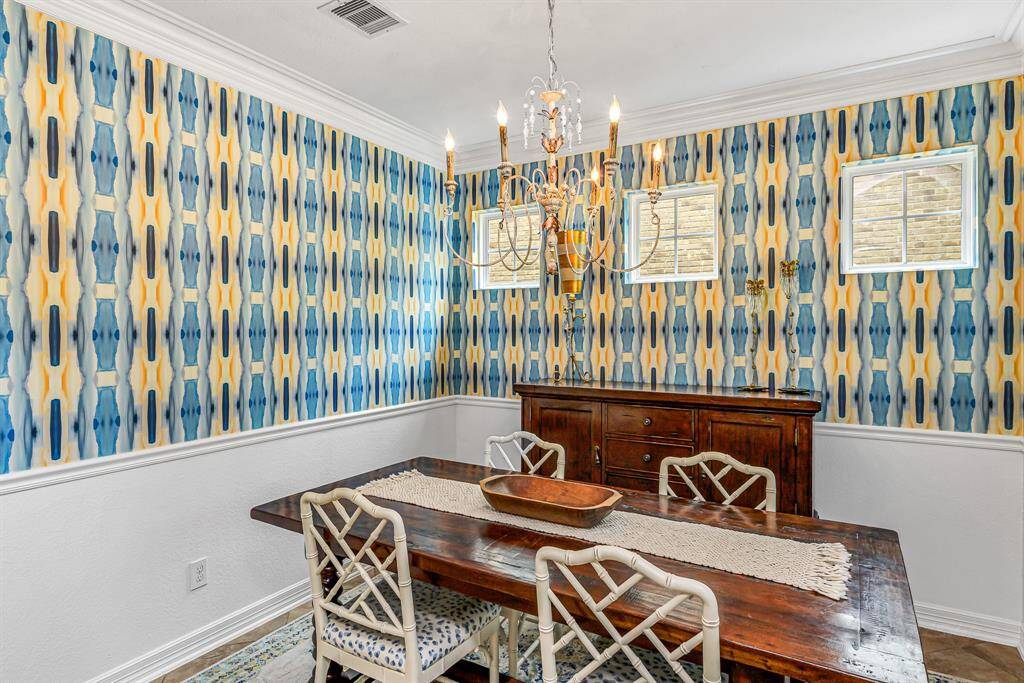The kitchen boasts granite counters, a gas cooktop and rich wood cabinetry. A walk-in pantry adds convenient storage and function.