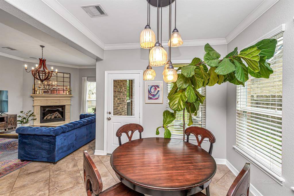 Spacious and welcoming, this family room offers ample space for a full seating setup. Neutral tones and backyard access make it both comfortable and functional.