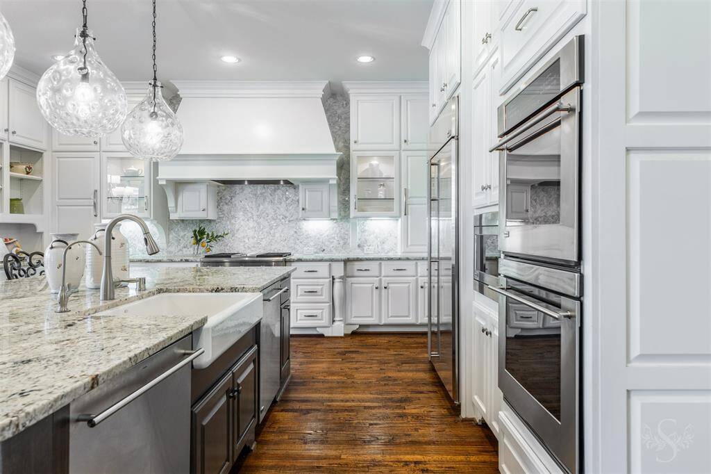 Large granite kitchen island offers plenty of space for meal prep and entertaining, with a breakfast bar perfect for casual dining under stylish pendant lighting. The abundance of counter space makes it easy to cook and gather, creating a welcoming atmosphere for family and friends. Includes whole house water softener and a reverse osmosis in kitchen.